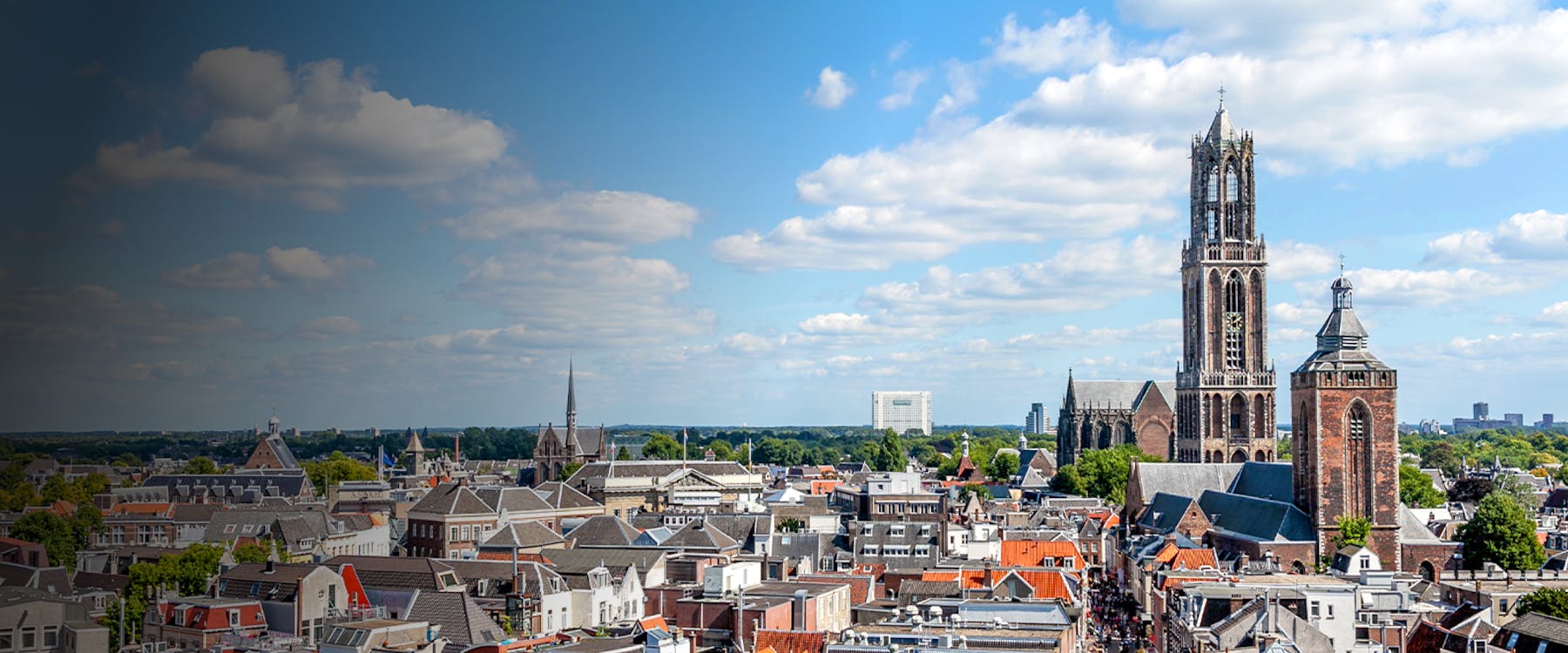 Utrecht skyline featuring the Dom Tower and historic buildings.