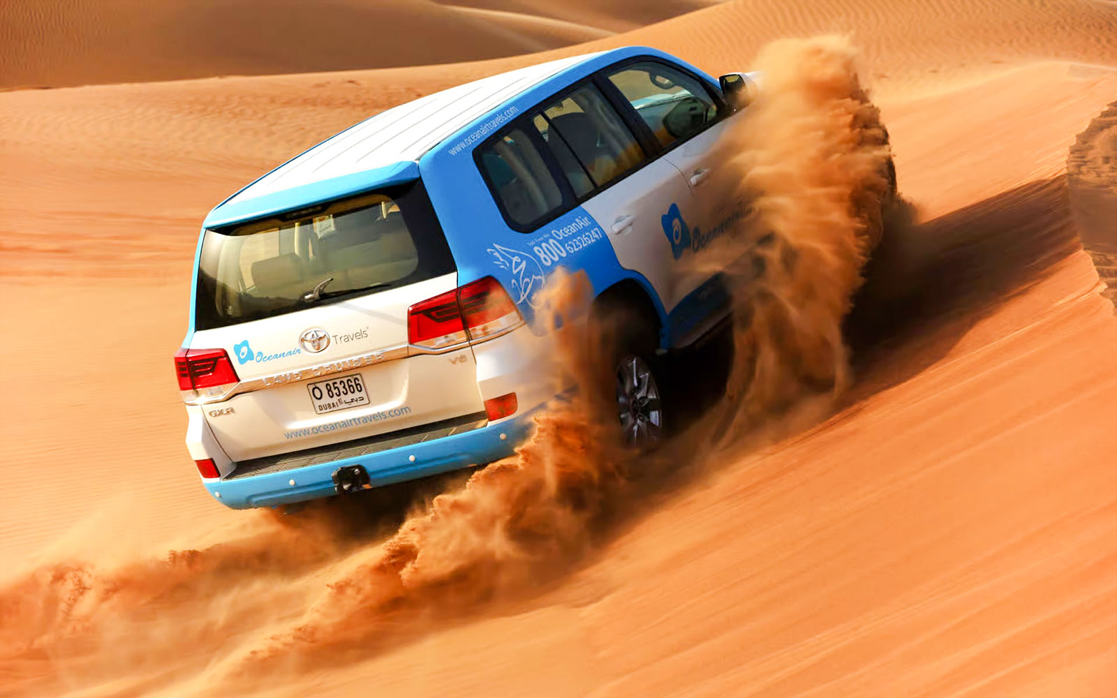 SUV driving through sand dunes during Abu Dhabi desert safari.