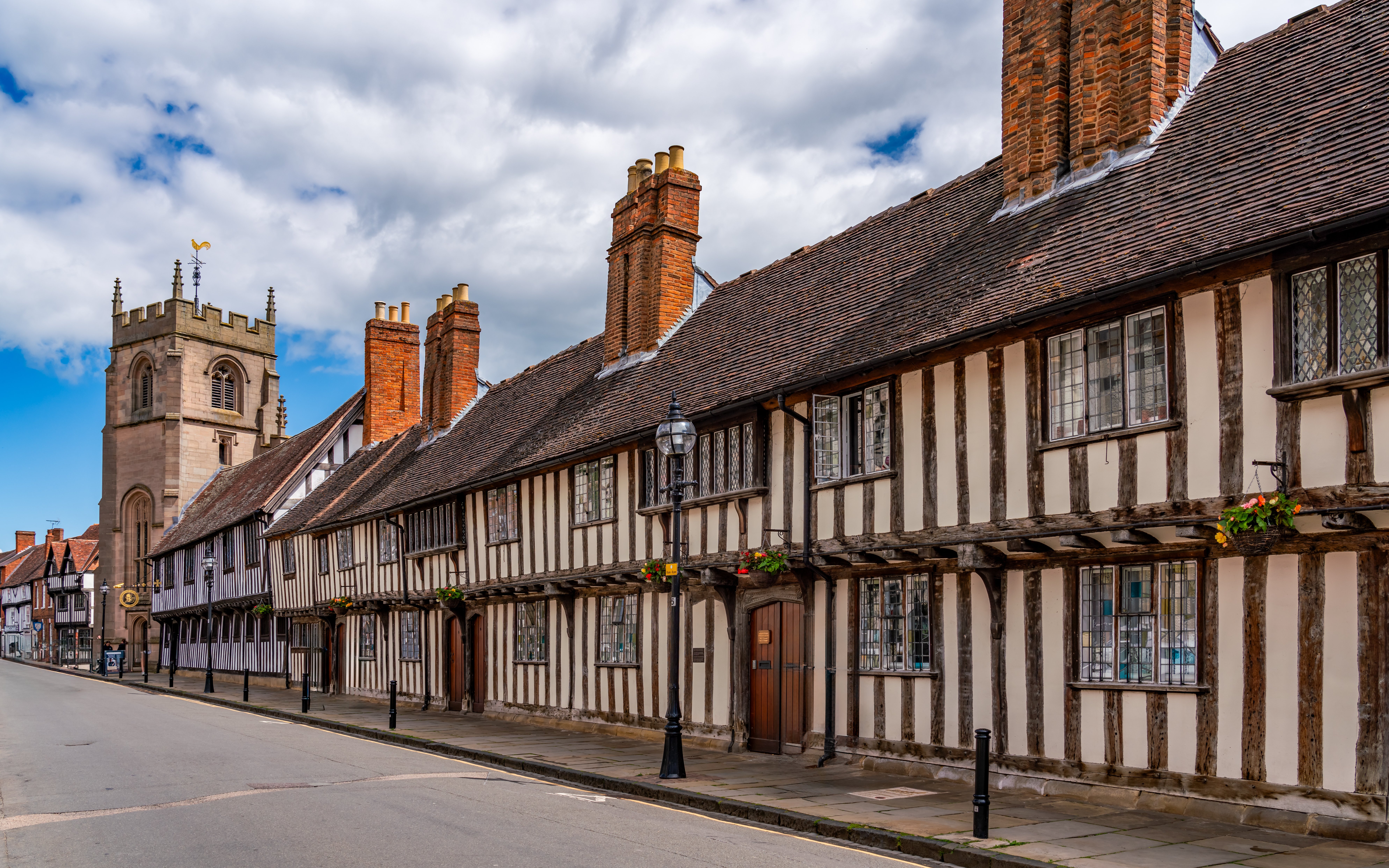 Historic half-timbered buildings and church tower in Stratford Upon Avon.