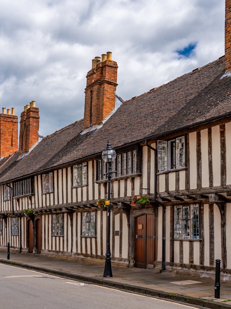 Historic half-timbered buildings and church tower in Stratford Upon Avon.