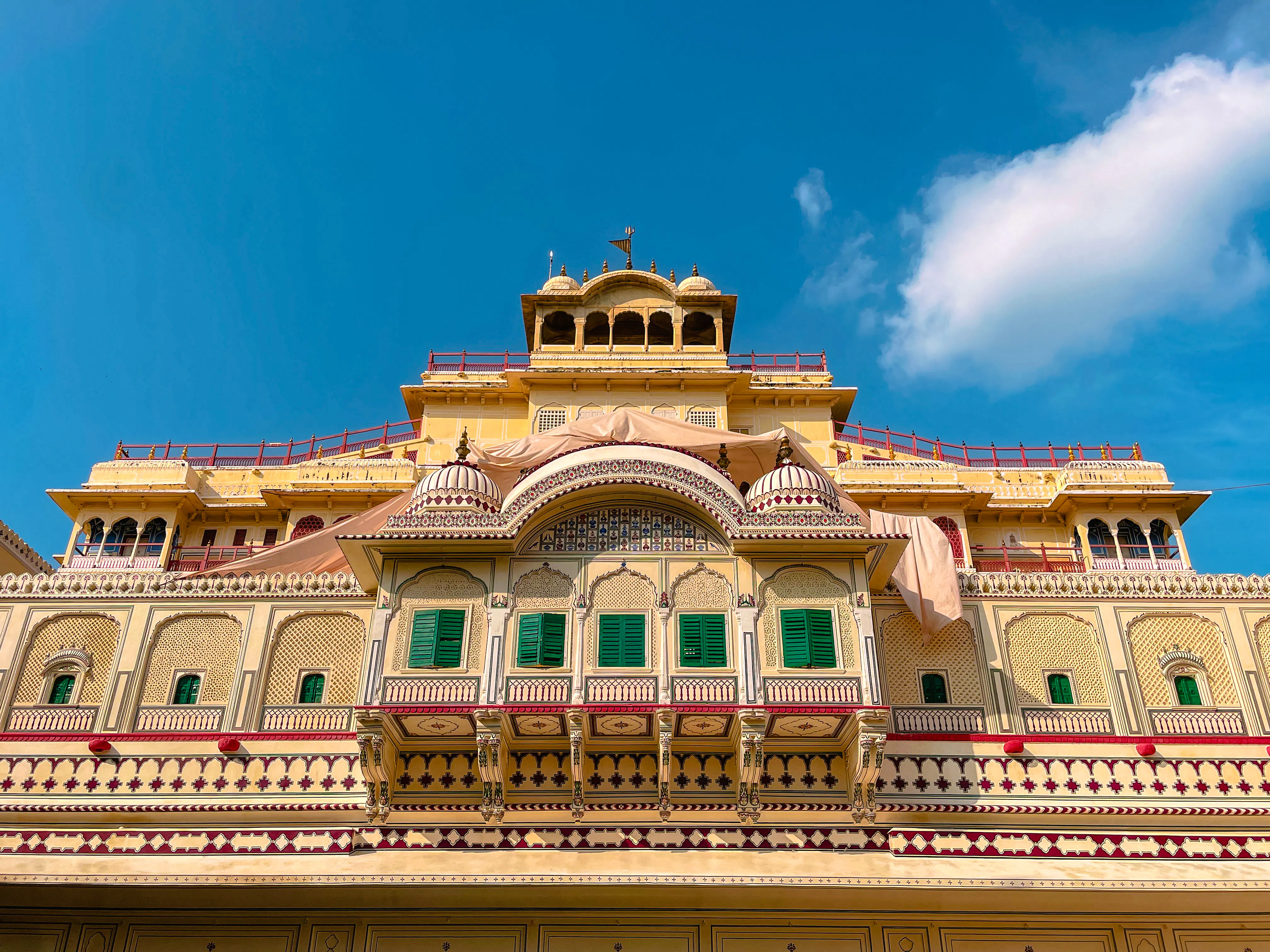 Facade of Jaipur's City Palace with ornate architecture, part of the Golden Triangle India Tour.