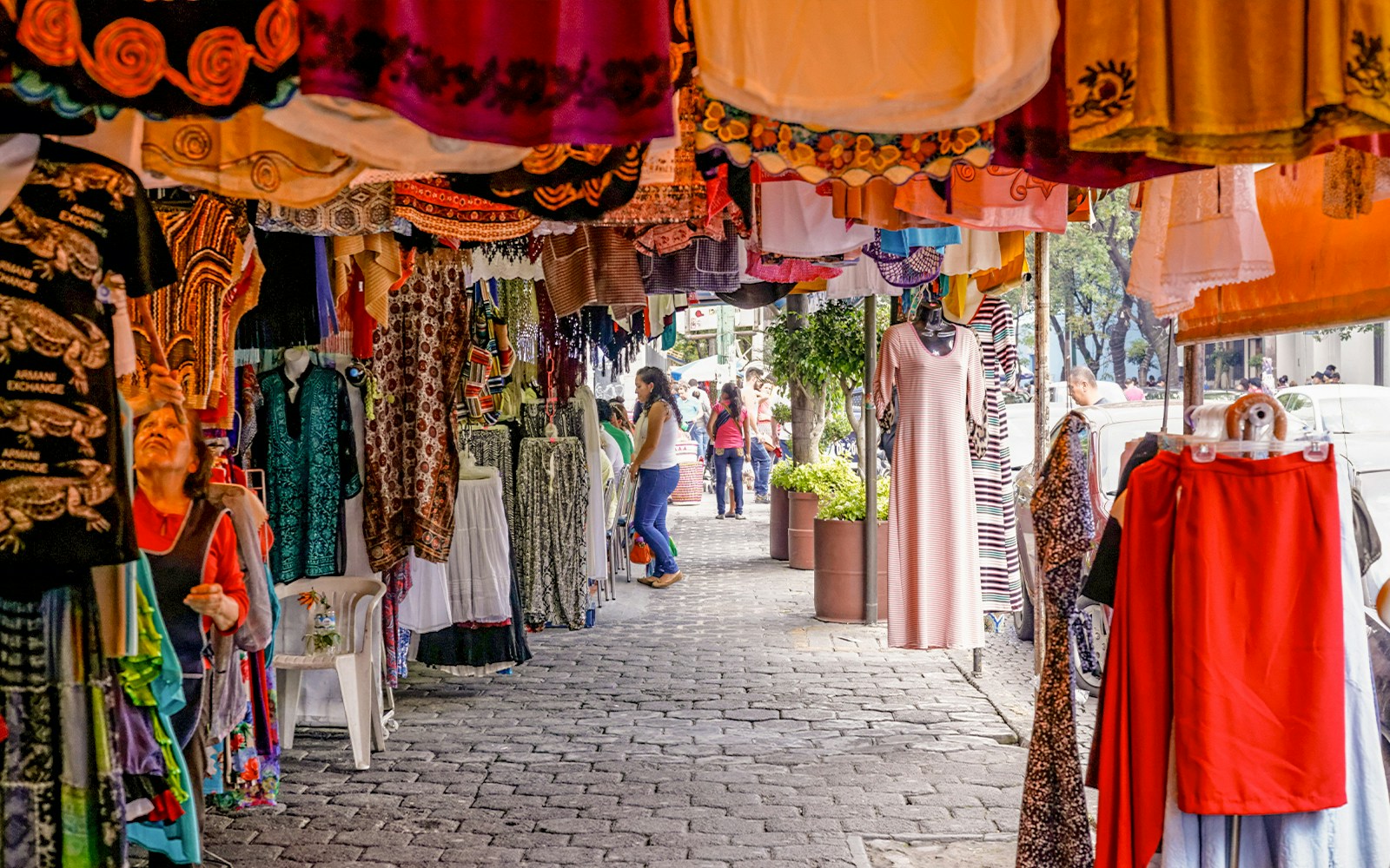 Colorful storefronts at Coyoacán Market, Mexico City, showcasing vibrant local crafts and goods.