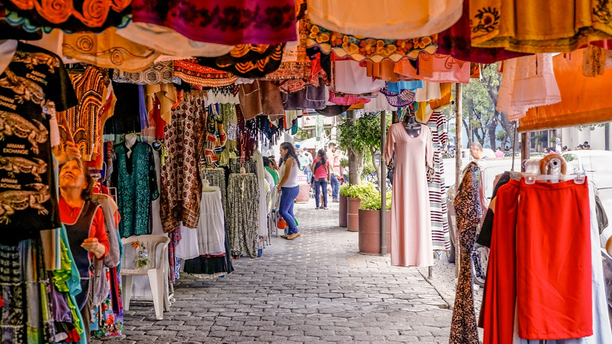 Colorful storefronts at Coyoacán Market, Mexico City, showcasing vibrant local crafts and goods.