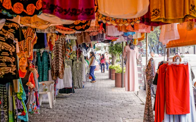 Colorful clothing stalls at Coyoacán Market, Mexico City.