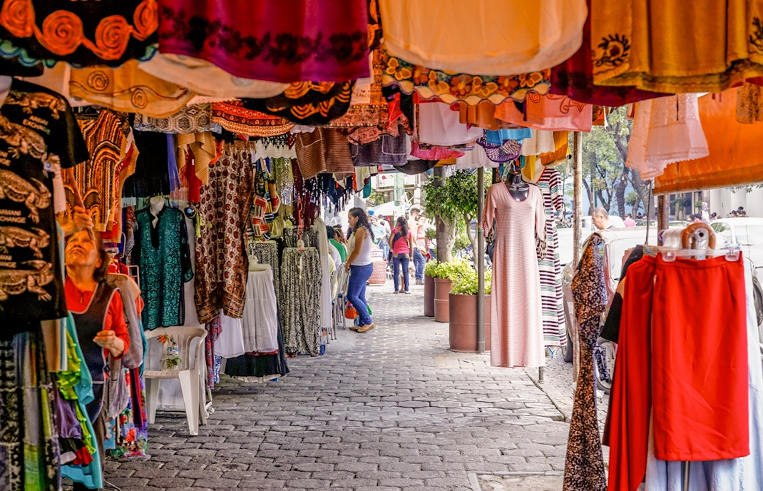 Colorful storefronts at Coyoacán Market, Mexico City, showcasing vibrant local crafts and goods.