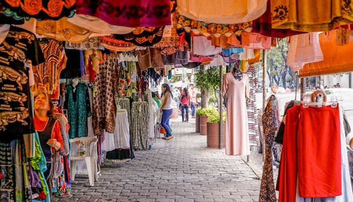 Colorful storefronts at Coyoacán Market, Mexico City, showcasing vibrant local crafts and goods.