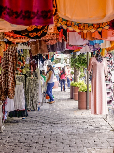Colorful clothing stalls at Coyoacán Market, Mexico City.
