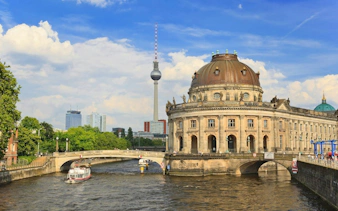 Berlin TV Tower and Bode Museum along the Spree River, part of a self-guided city exploration game.