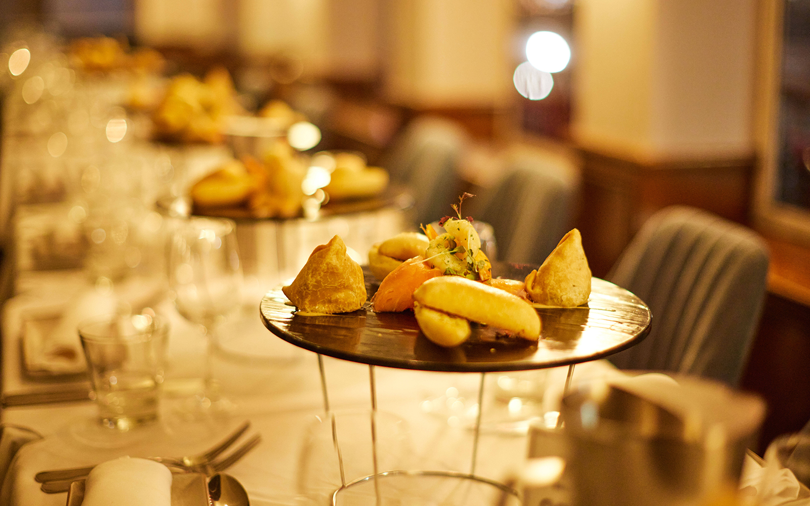 Elegant dining setup with gourmet appetizers on a cabaret cruise dinner table.