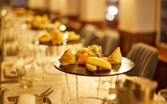 Elegant dining setup with gourmet appetizers on a cabaret cruise dinner table.