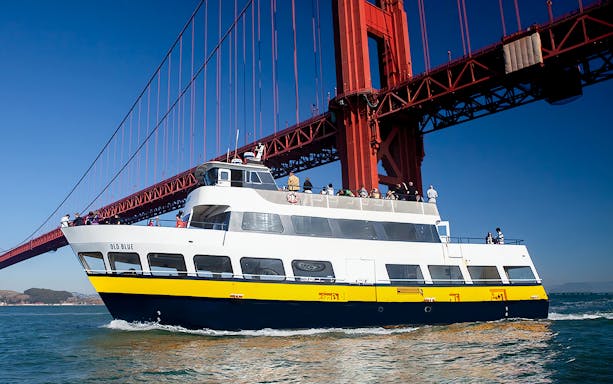 Tour boat cruising under the Golden Gate Bridge in San Francisco.