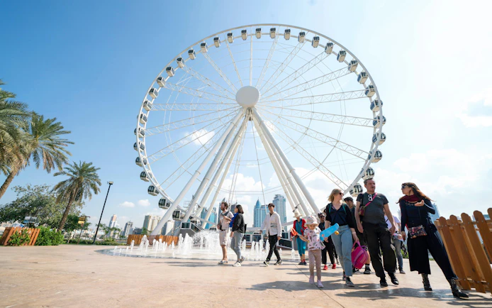 Ferris wheel and visitors at Al Montazah Parks, Island of Legends.