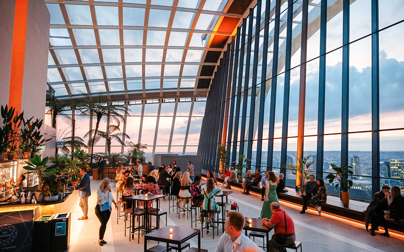 Guests enjoying the view at Sky Garden London during sunset.