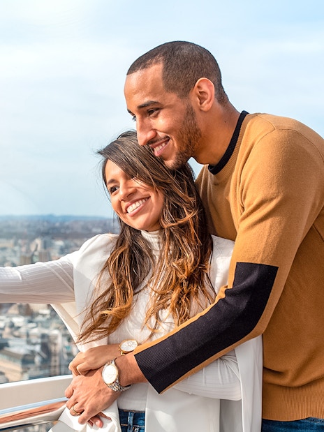 Visitors taking a selfie on the London Eye with cityscape views.