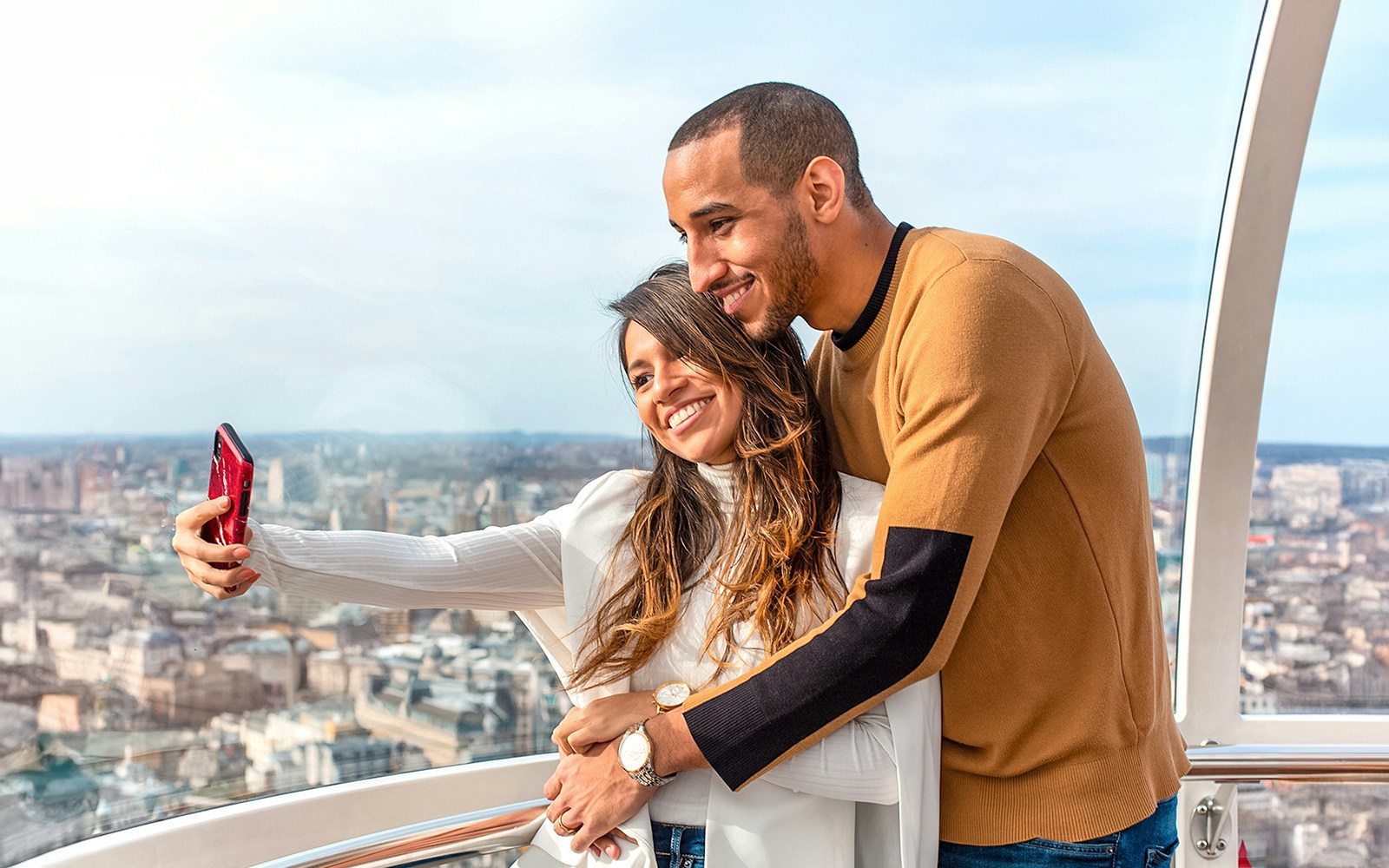 Visitors on the London Eye overlooking Westminster Abbey and the River Thames.