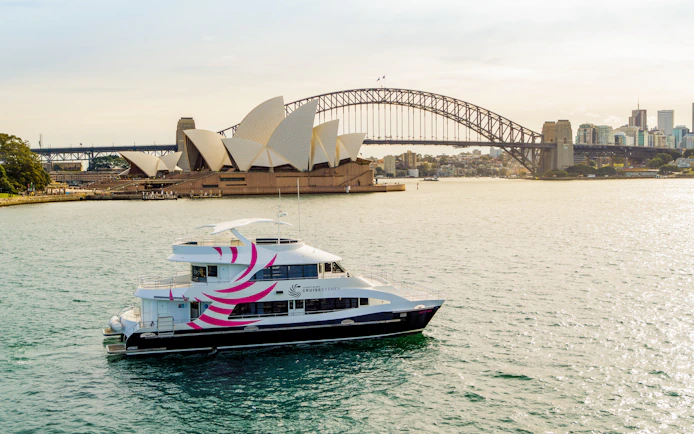 Cruise ship on Sydney Harbour with Opera House and Harbour Bridge in the background.