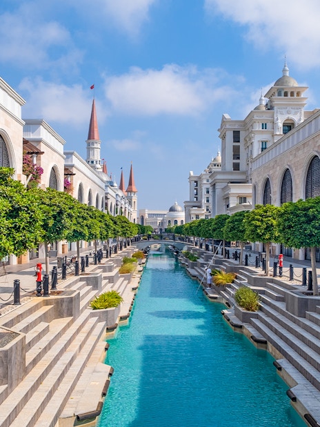 Wild river ride at Land of Legends Theme Park with canal and architectural buildings.