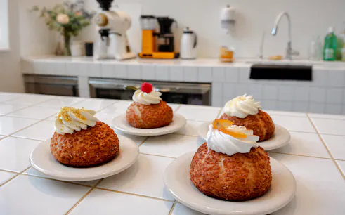 Pastries with cream and fruit toppings on a counter, featured in Prenzlauer Berg food tour, Berlin.
