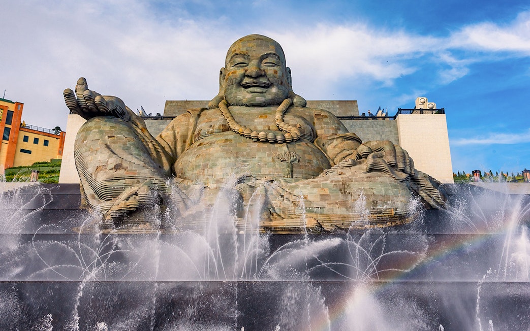 Giant Buddha statue with water fountains at Ba Den Mountain, Tay Ninh, Vietnam.