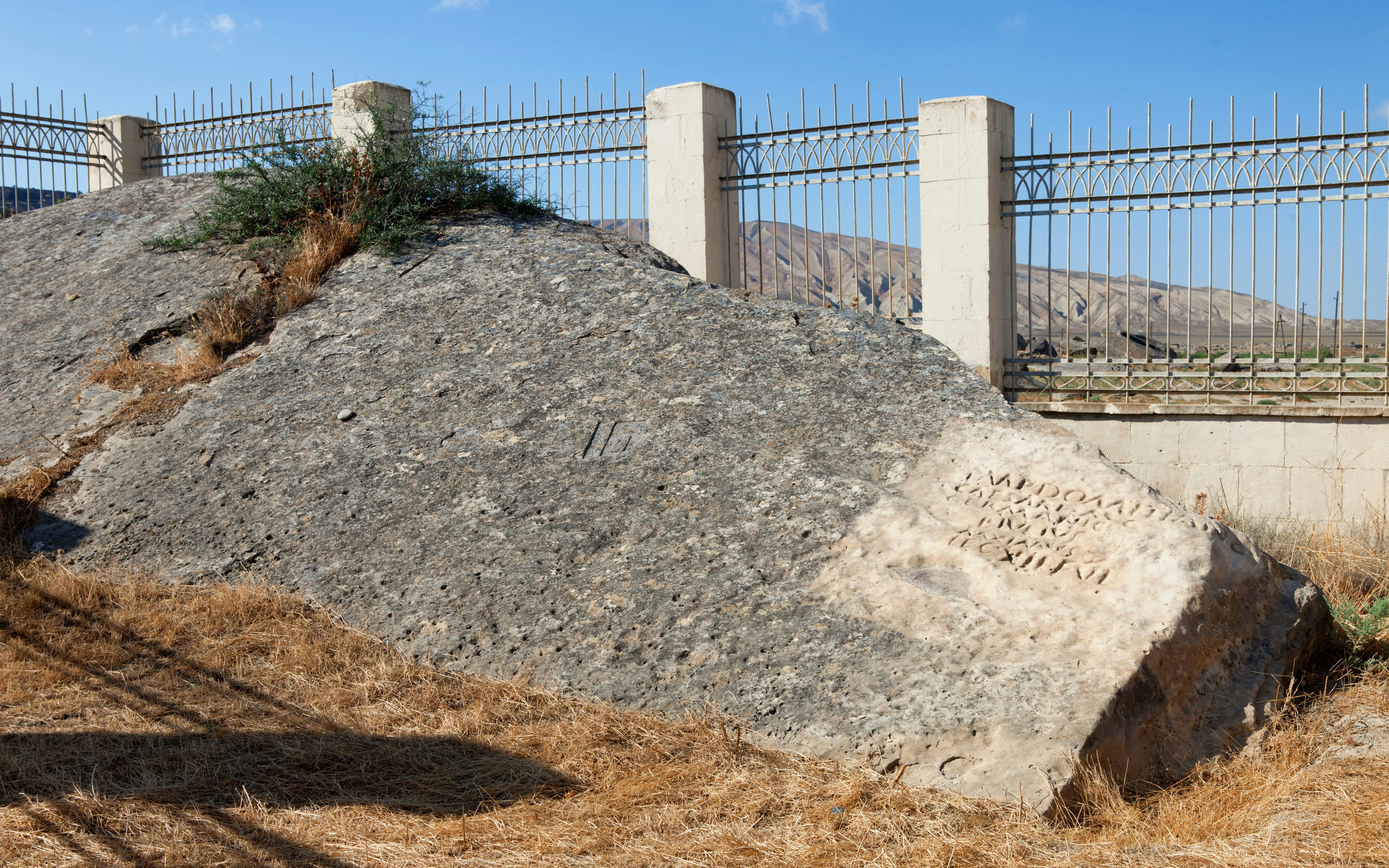 Roman inscription on rock in Qobustan park near Caspian Sea, Azerbaijan.