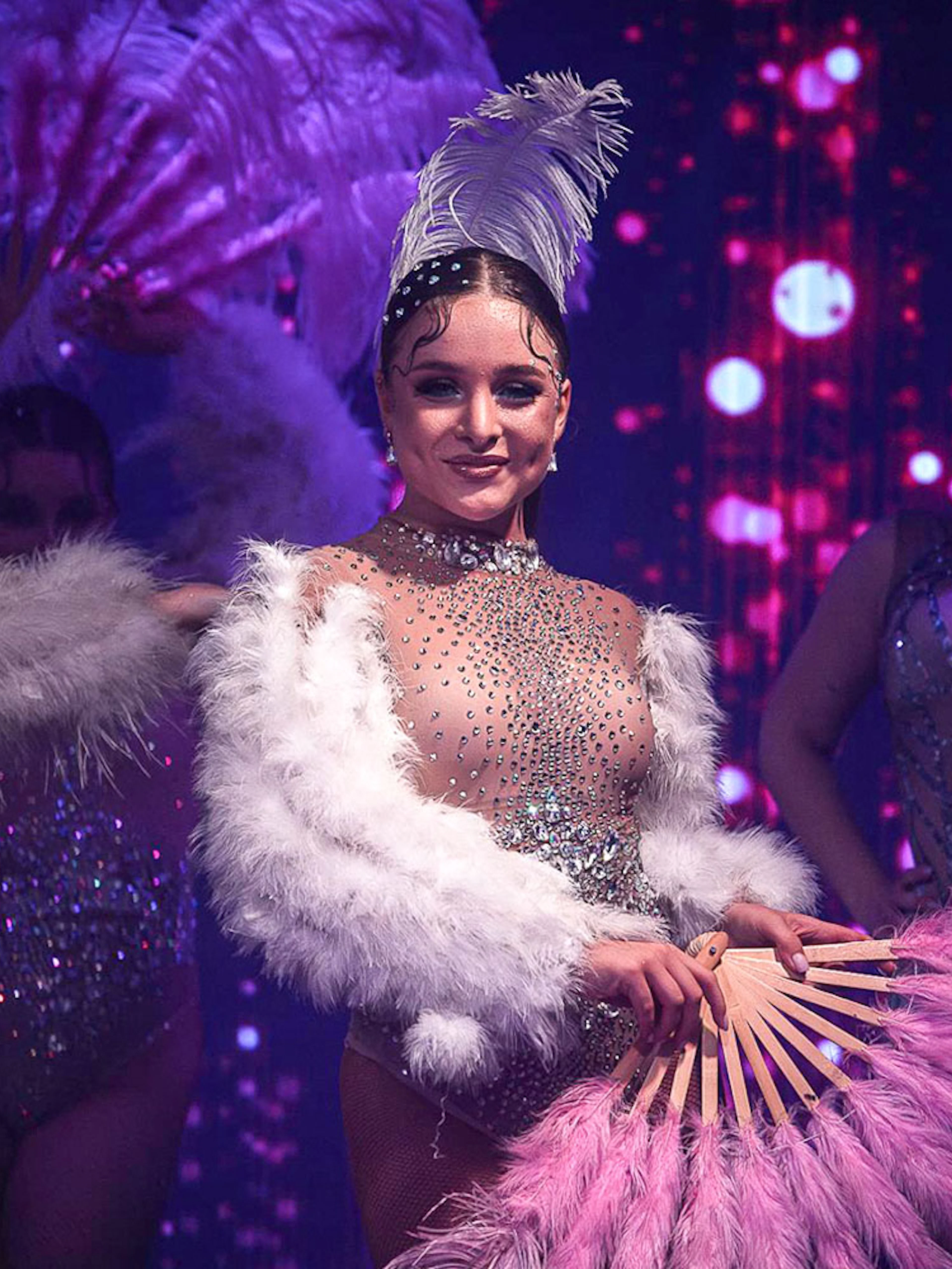 Cabaret dancers with feather fans performing at La Scène Dinner Show in Prague.