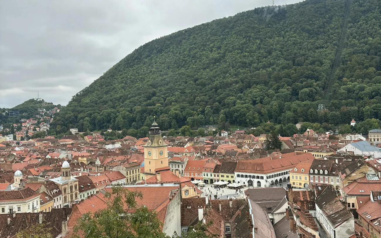 Brasov cityscape with Council Square and Tampa Mountain in the background.