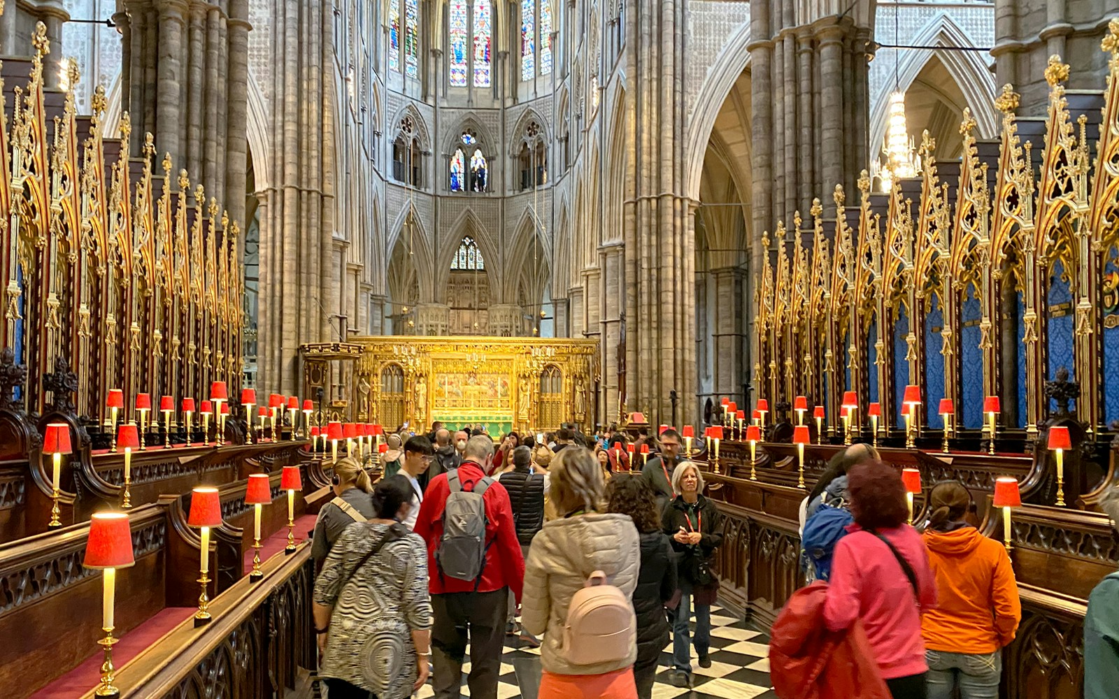 Visitors exploring the ornate interior of Westminster Abbey, London.