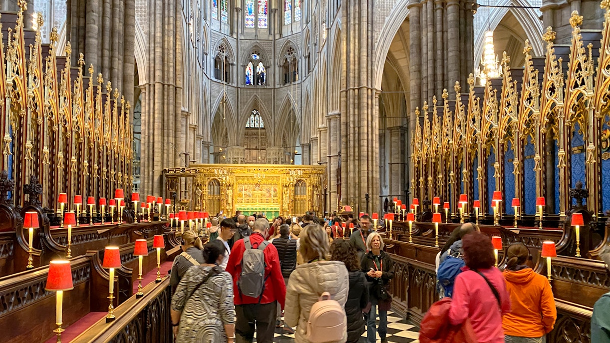 Visitors exploring the ornate interior of Westminster Abbey, London.