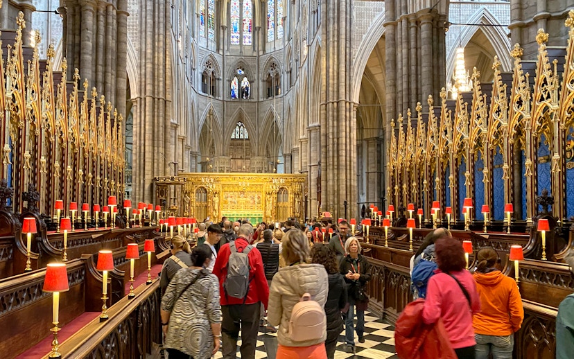 Visitors exploring the ornate interior of Westminster Abbey, London.
