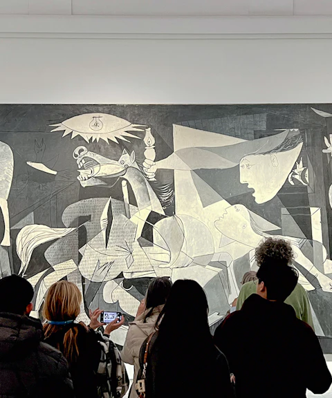 Visitors viewing Picasso's Guernica, 1937, at Reina Sofia Museum, Madrid.