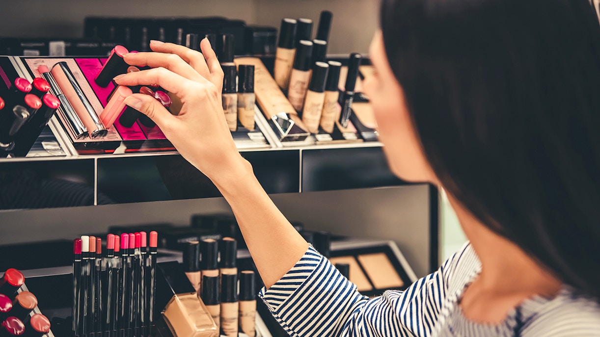 Shopper selecting lipstick at Val d’Europe Shopping Center.