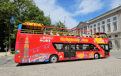 Porto City Sightseeing bus with tourists on a hop-on hop-off tour.