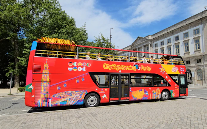 Porto City Sightseeing bus with tourists on a hop-on hop-off tour.