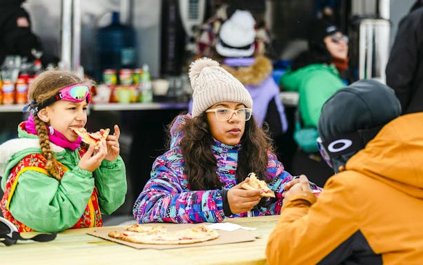 Tourists enjoying pizza at Farellones Park.