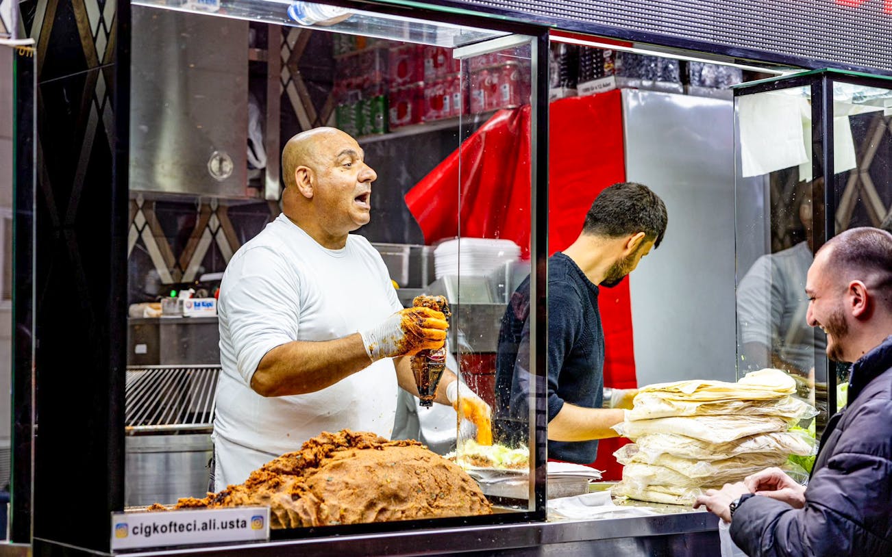 Street vendor preparing traditional Turkish food at a rooftop event in Istanbul.