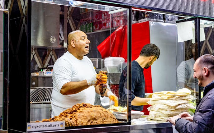 Street vendor preparing traditional Turkish food at a rooftop event in Istanbul.