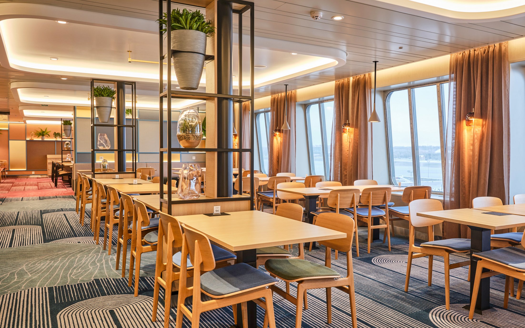 Buffet dining area on ferry from Tallinn to Helsinki with large windows and modern decor.