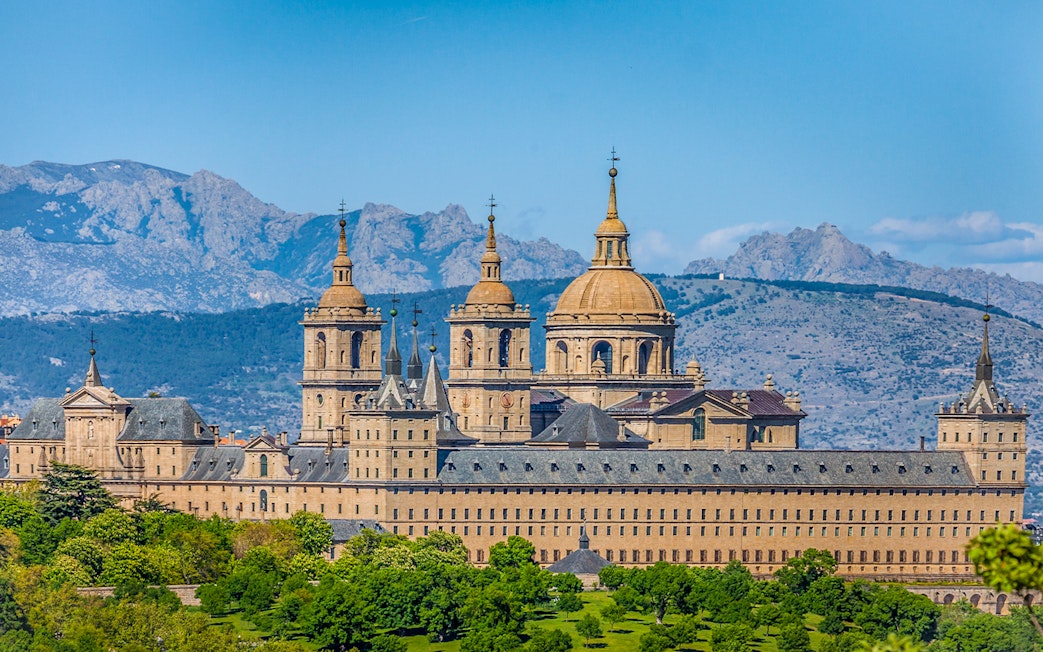 San Lorenzo de El Escorial monastery with mountain backdrop on private tour.