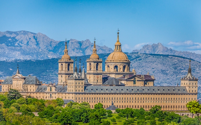 San Lorenzo de El Escorial monastery with mountain backdrop on private tour.