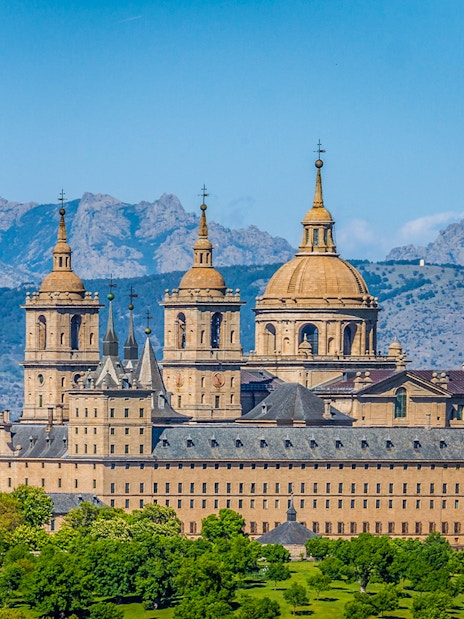 San Lorenzo de El Escorial monastery with mountain backdrop on private tour.