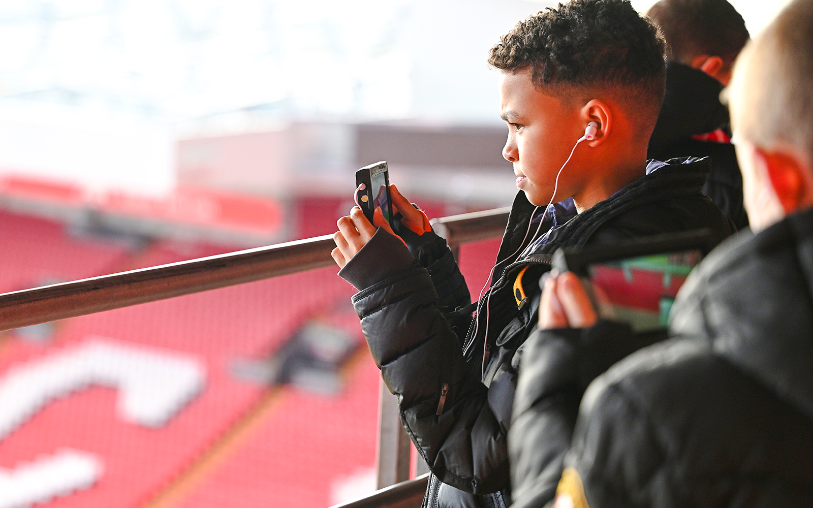 Guests taking photos at Anfield Stadium, Liverpool.