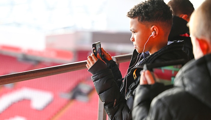 Guests taking photos at Anfield Stadium, Liverpool.