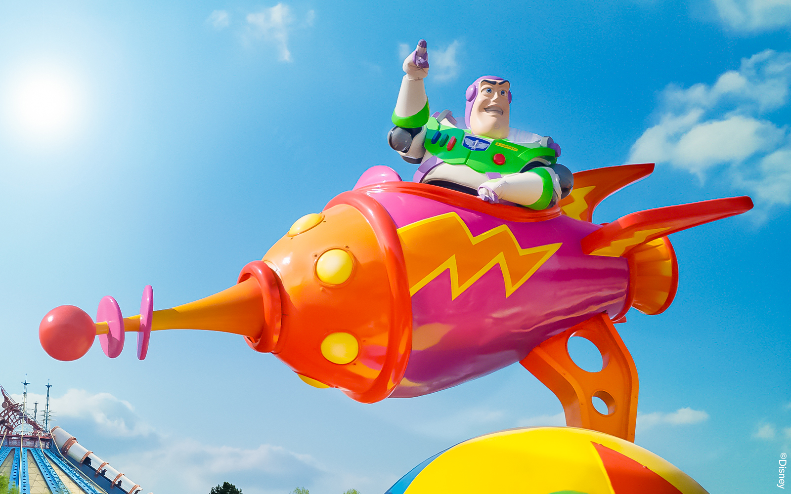 Buzz Lightyear on colorful rocket at Disneyland Paris Park.