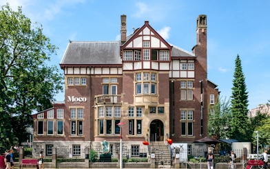 Moco Museum exterior in Amsterdam, showcasing Banksy and Dalí exhibits.