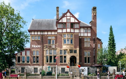 Visitors viewing Banksy artworks at Moco Museum with Moco Museum Tickets.