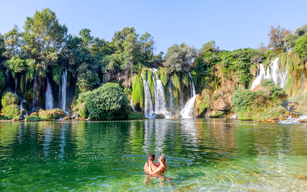 Guests enjoying a swim at Kravica Waterfalls, Bosnia and Herzegovina.