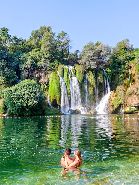 Guests enjoying a swim at Kravica Waterfalls, Bosnia and Herzegovina.