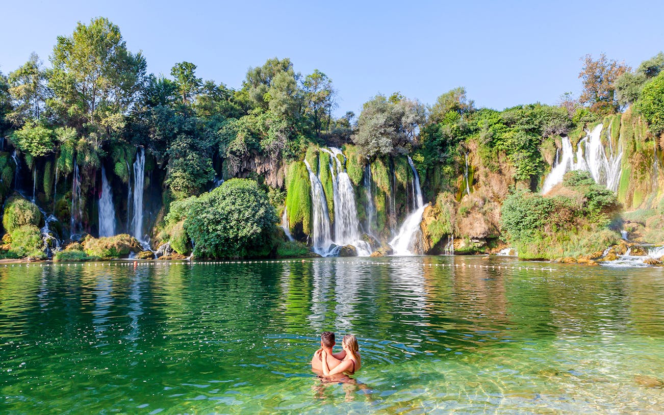 Guests enjoying a swim at Kravica Waterfalls, Bosnia and Herzegovina.