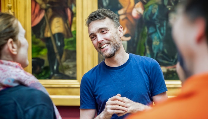 A guide giving a tour of a hitroy musuem in Vienna