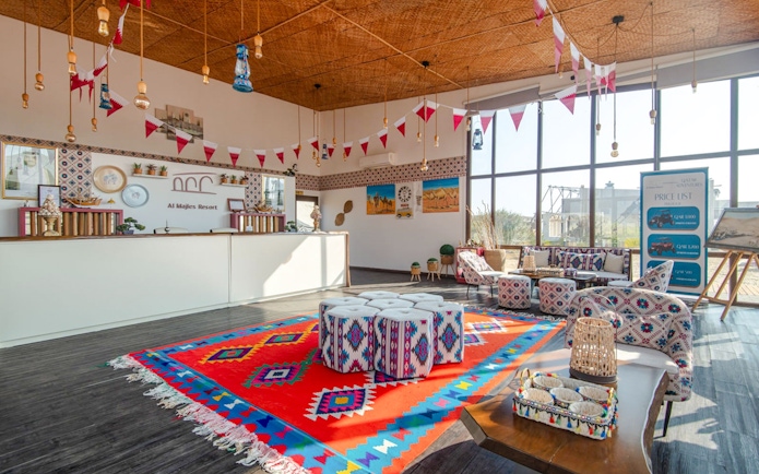 Seating area with colorful decor at Al Majles Resort reception.
